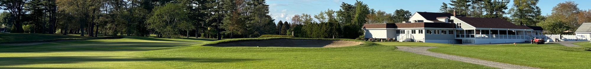 Image of golf ball on tee on grass.